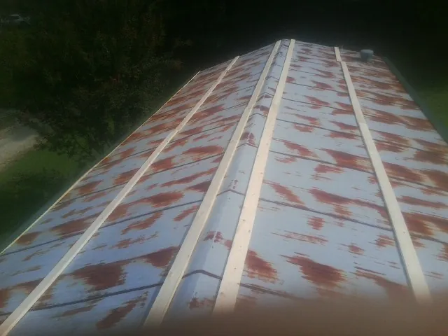 Rusted metal roof panels with new wood purlins before replacement — Storm Damage Roof Repair in Elko by Roofing Brothers